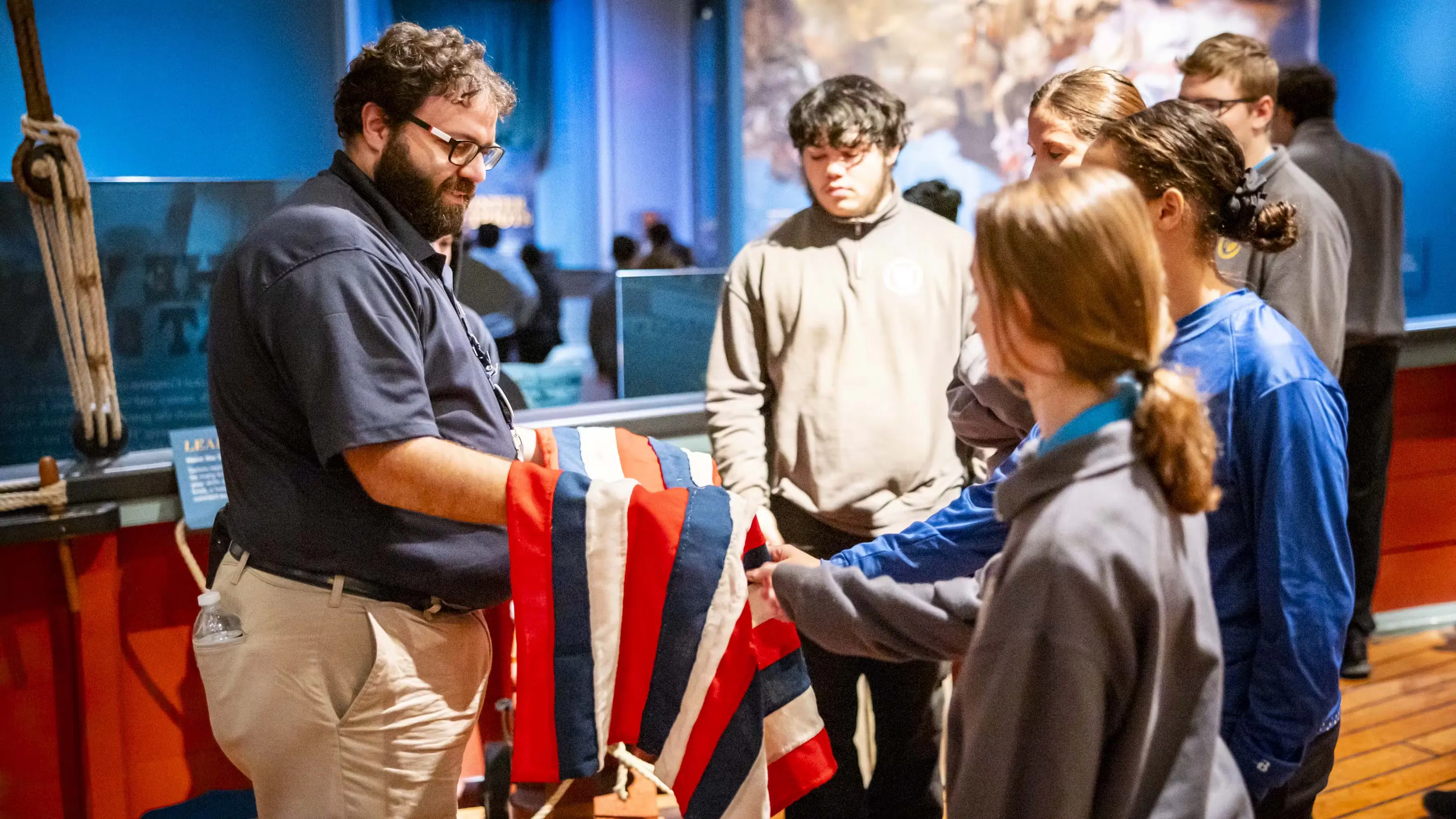 A Museum educator interacting with students.