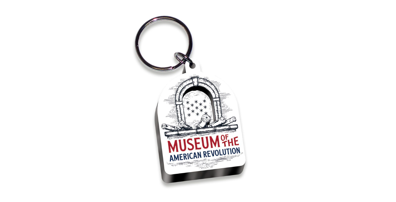 This keychain features the row of five cannons and the stone arch around thirteen stars atop the Museum of the American Revolution name.