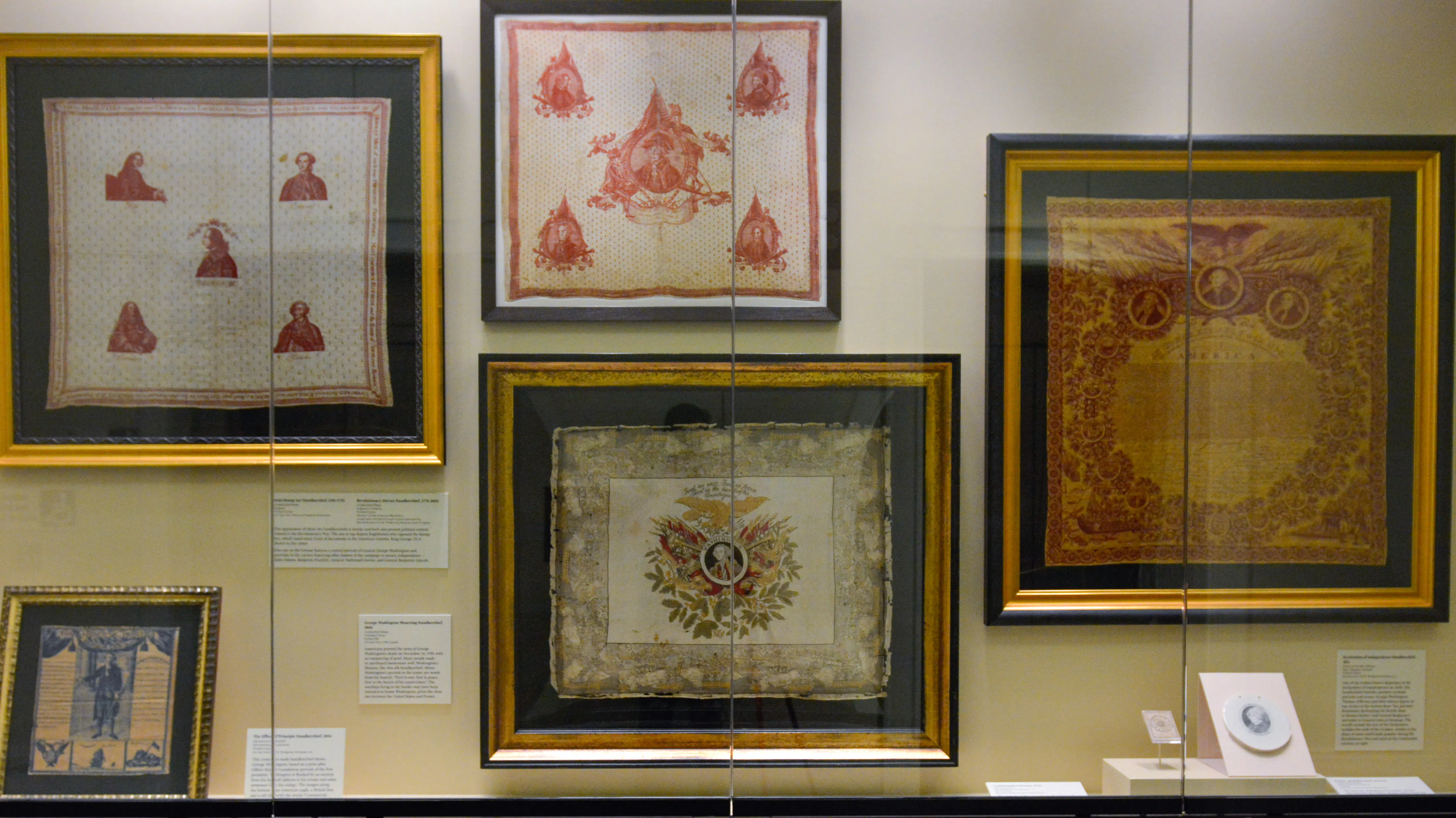 A display of five historic handkerchiefs in the Museum's second-floor atrium display case.