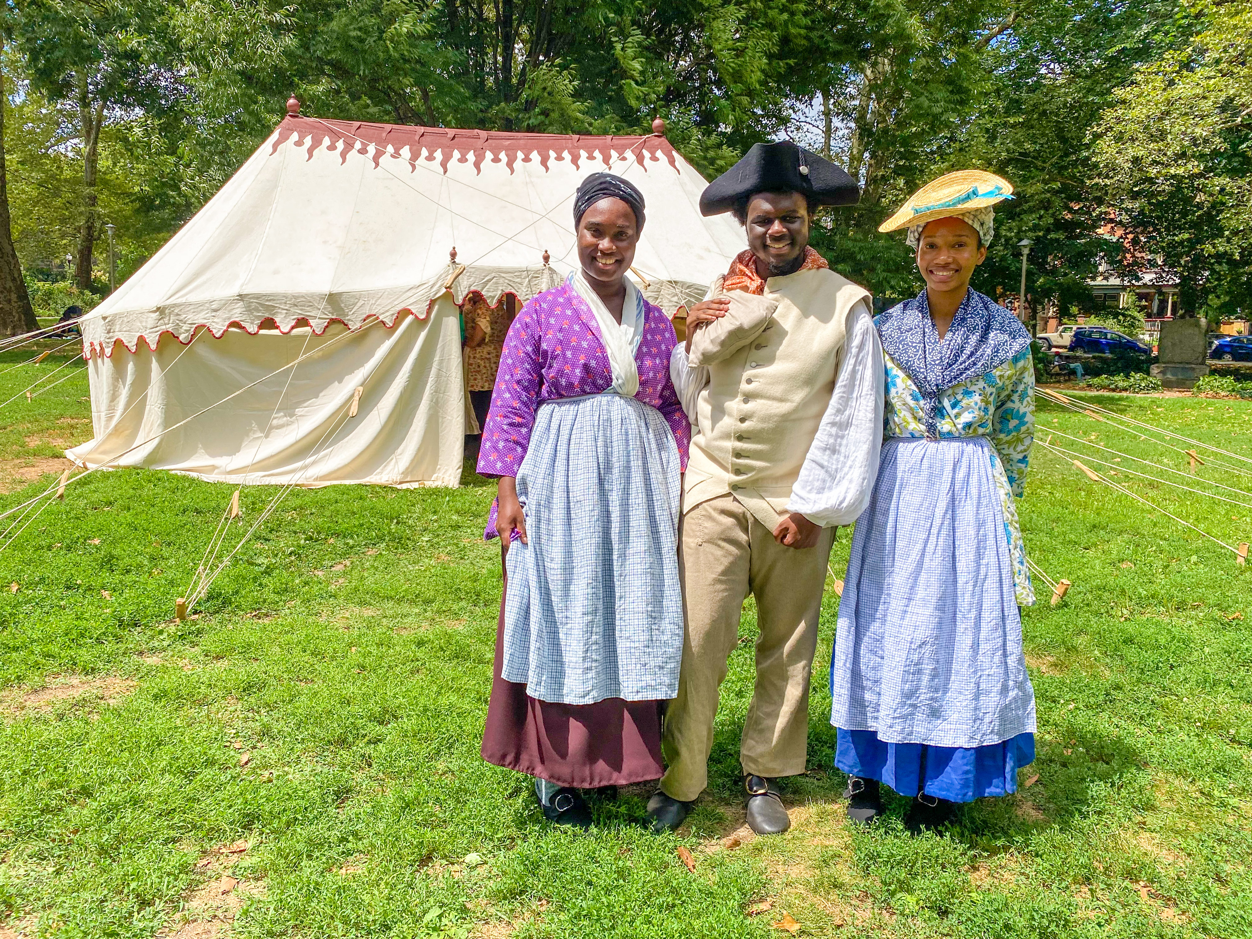 Three students from the Museum's Living History Youth Summer Institute pose for a photo in from the Museum's recreated George Washington's tent in Clark Park.
