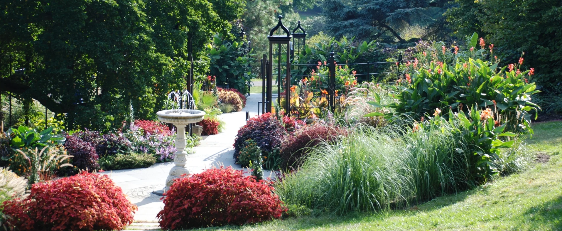 This image shows one of the gardens with flowers and a small fountain at Morris Arboretum.