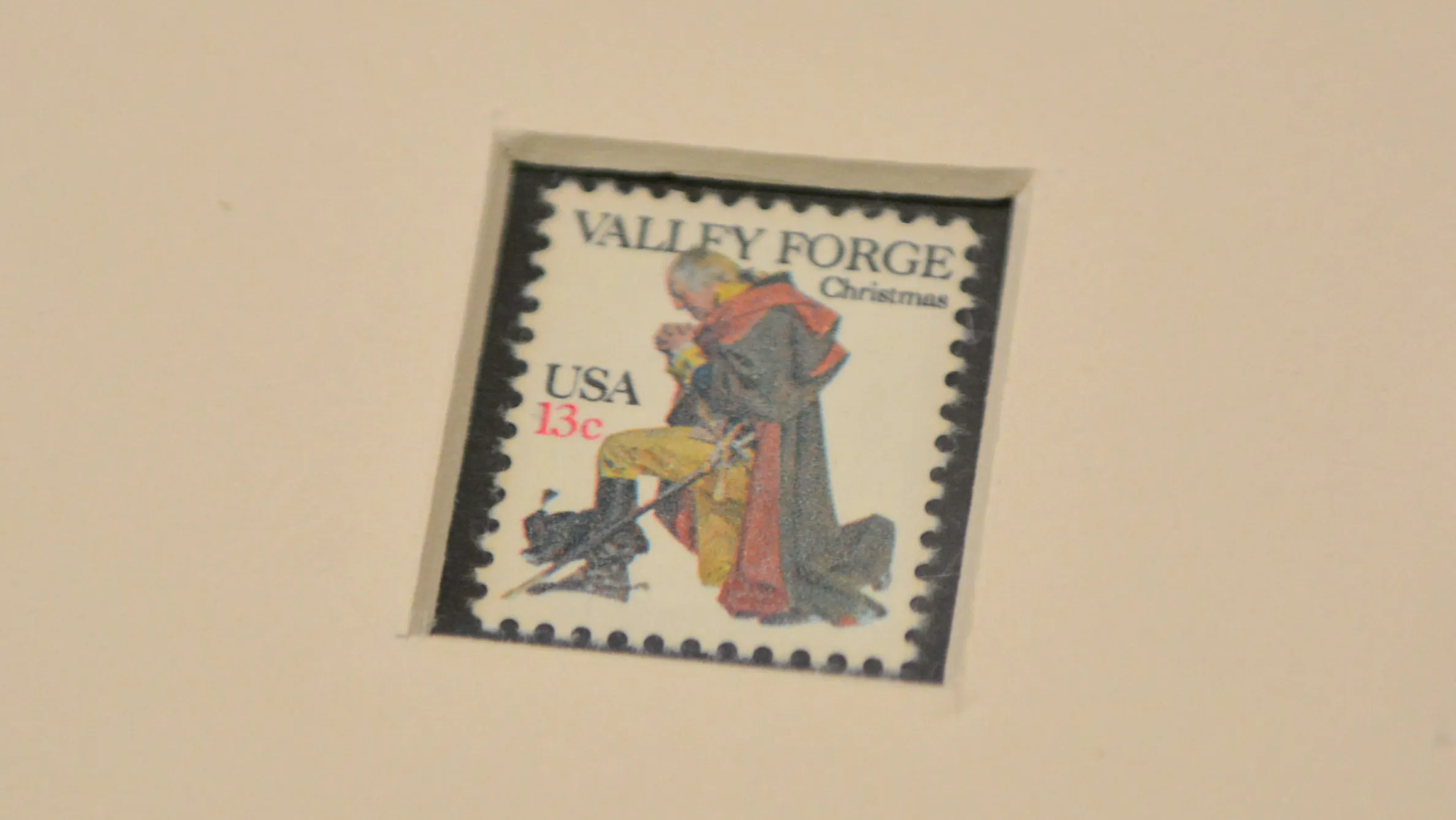 A 13-cent stamp featuring an image of Washington on bended knee praying at Valley Forge.