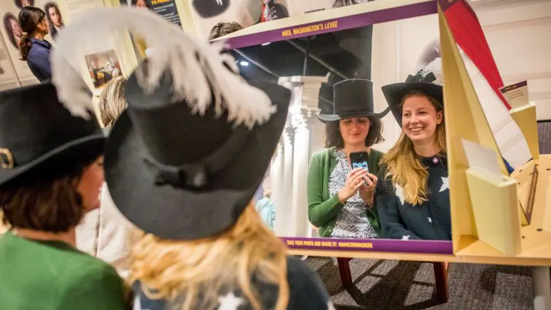 Museum guests taking a mirror selfie