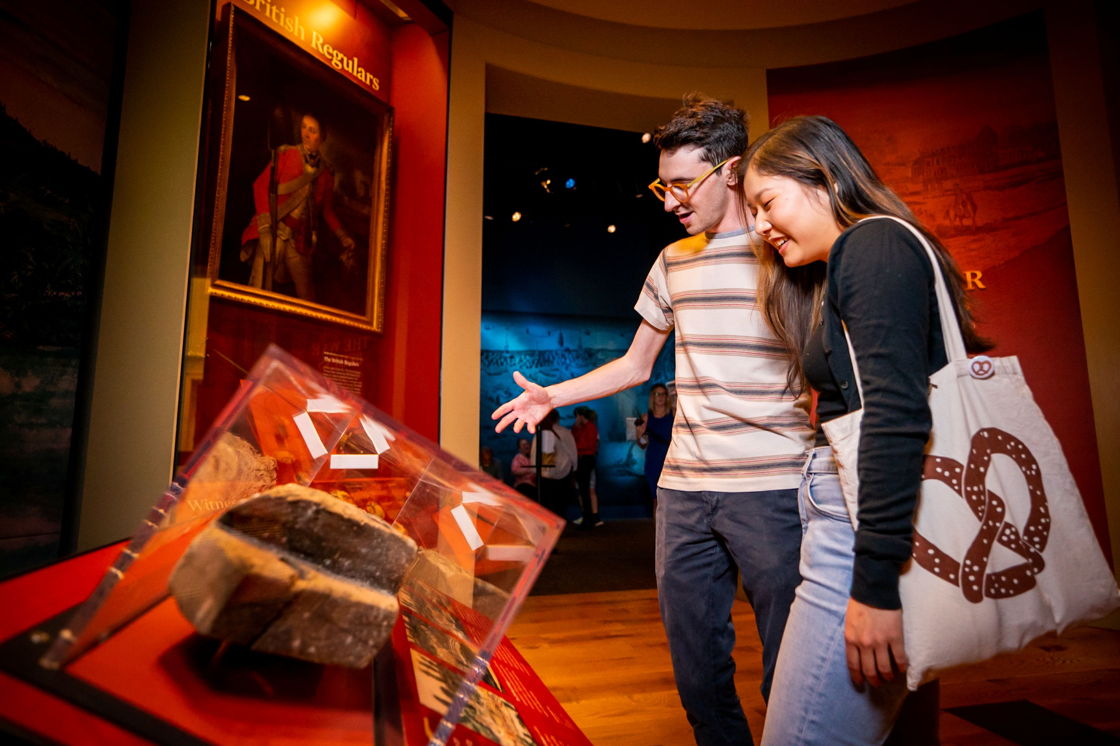 Two guests look at a display case in the Museum