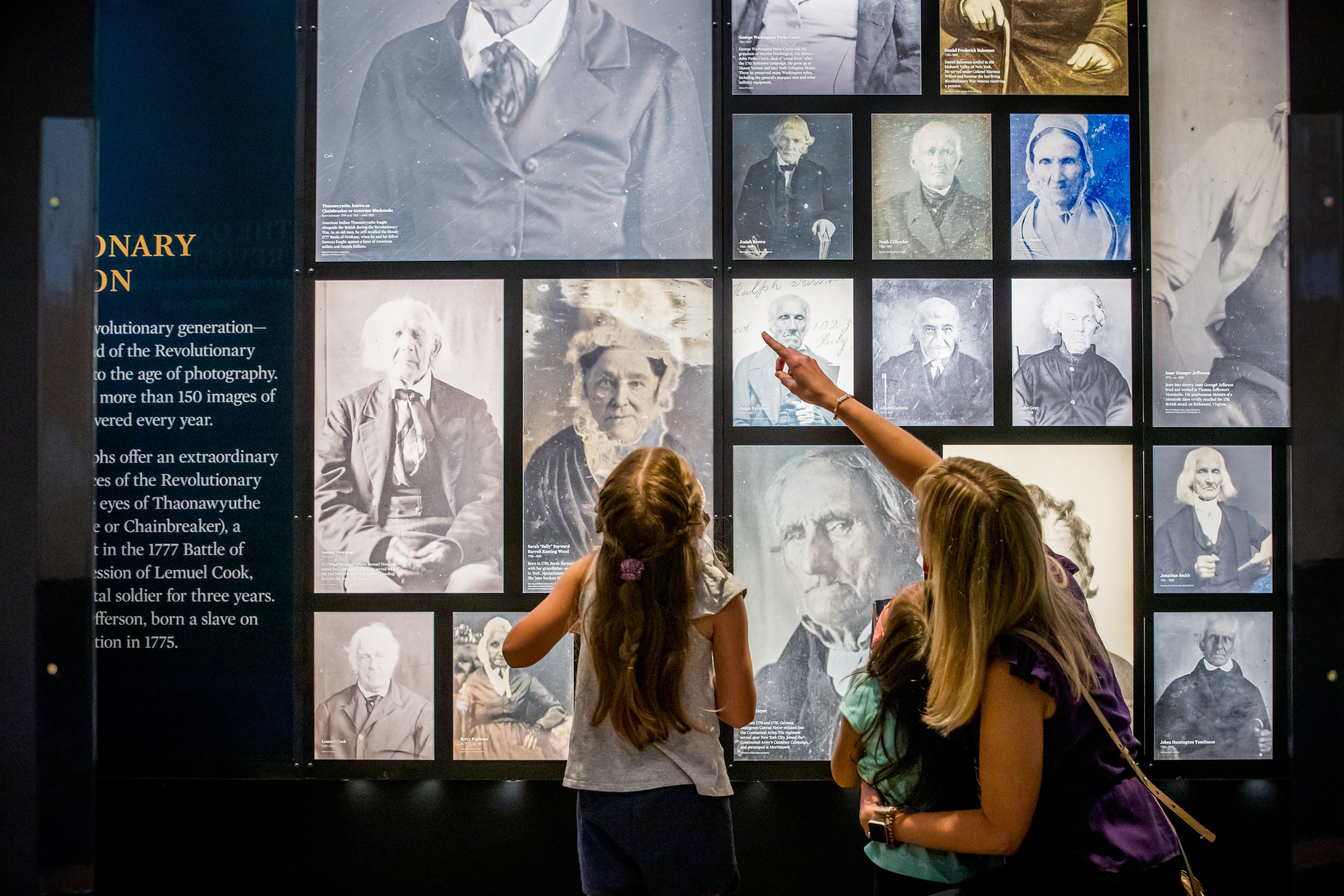 Guests with masks enjoy the images of Revolutionary War veterans.
