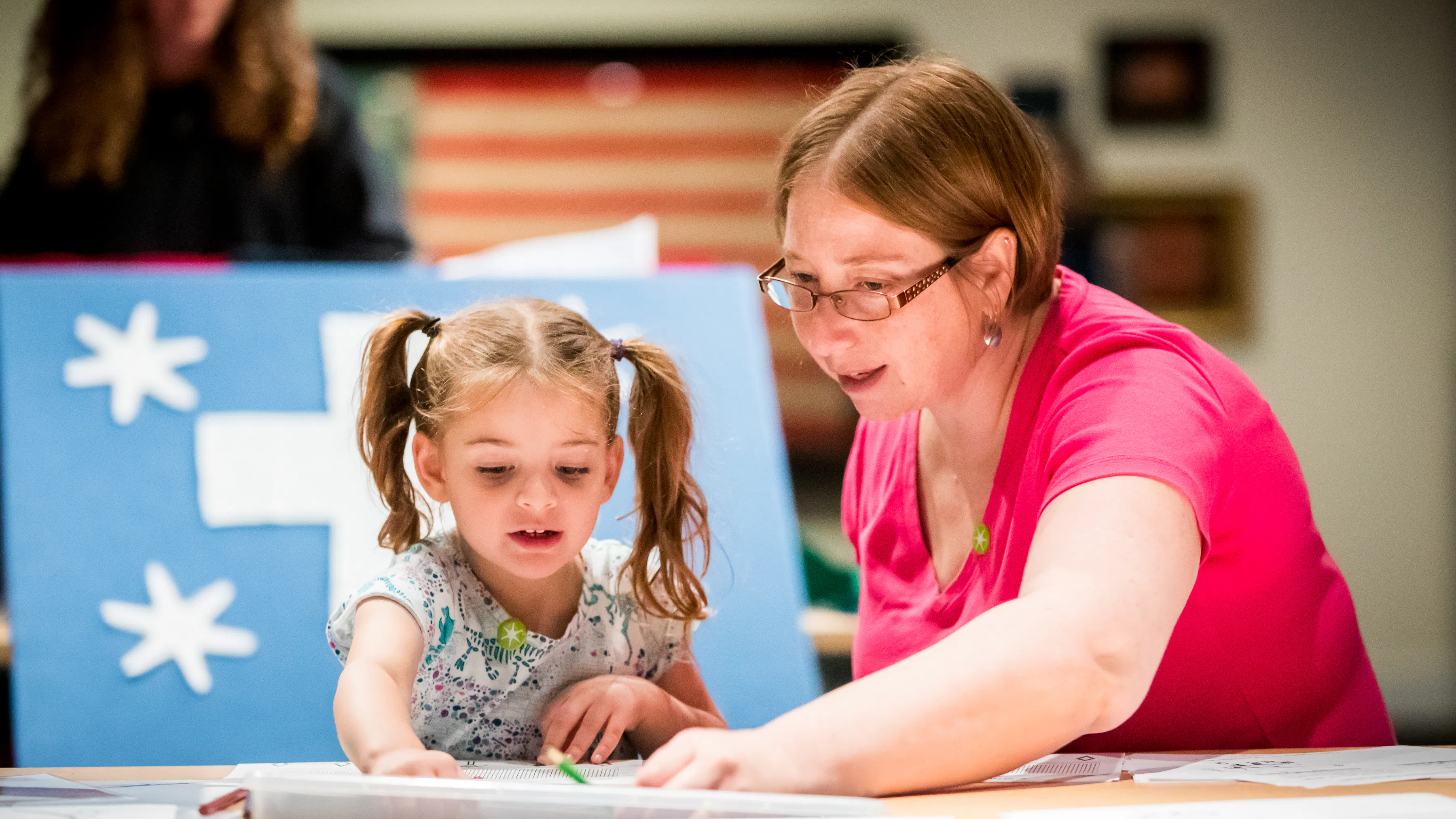 A mother and daughter draw pictures during the Museum's 2019 summer exhibition, A New Constellation.