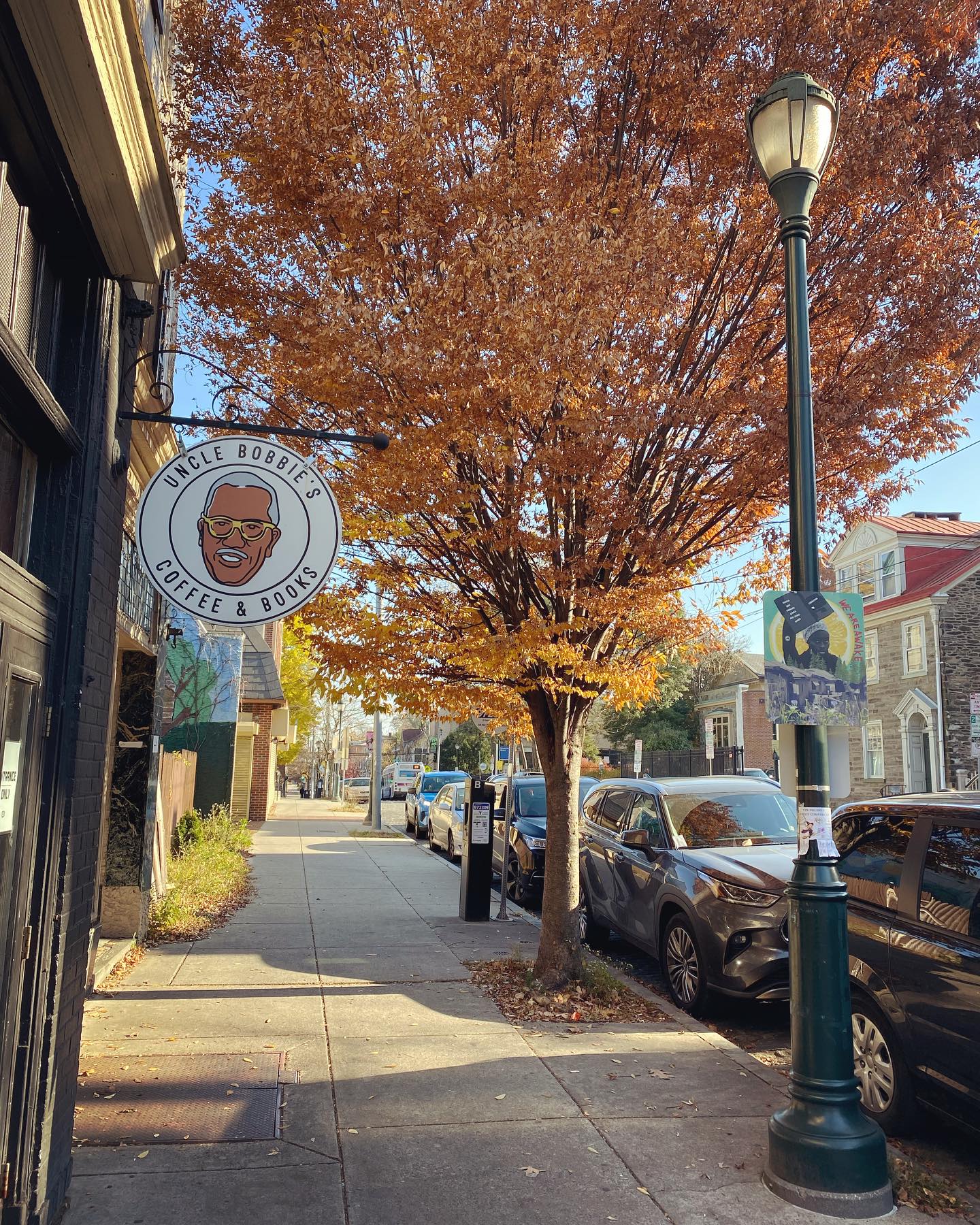 This image shows the white sign with character face for Uncle Bobbie's Books in Germantown.