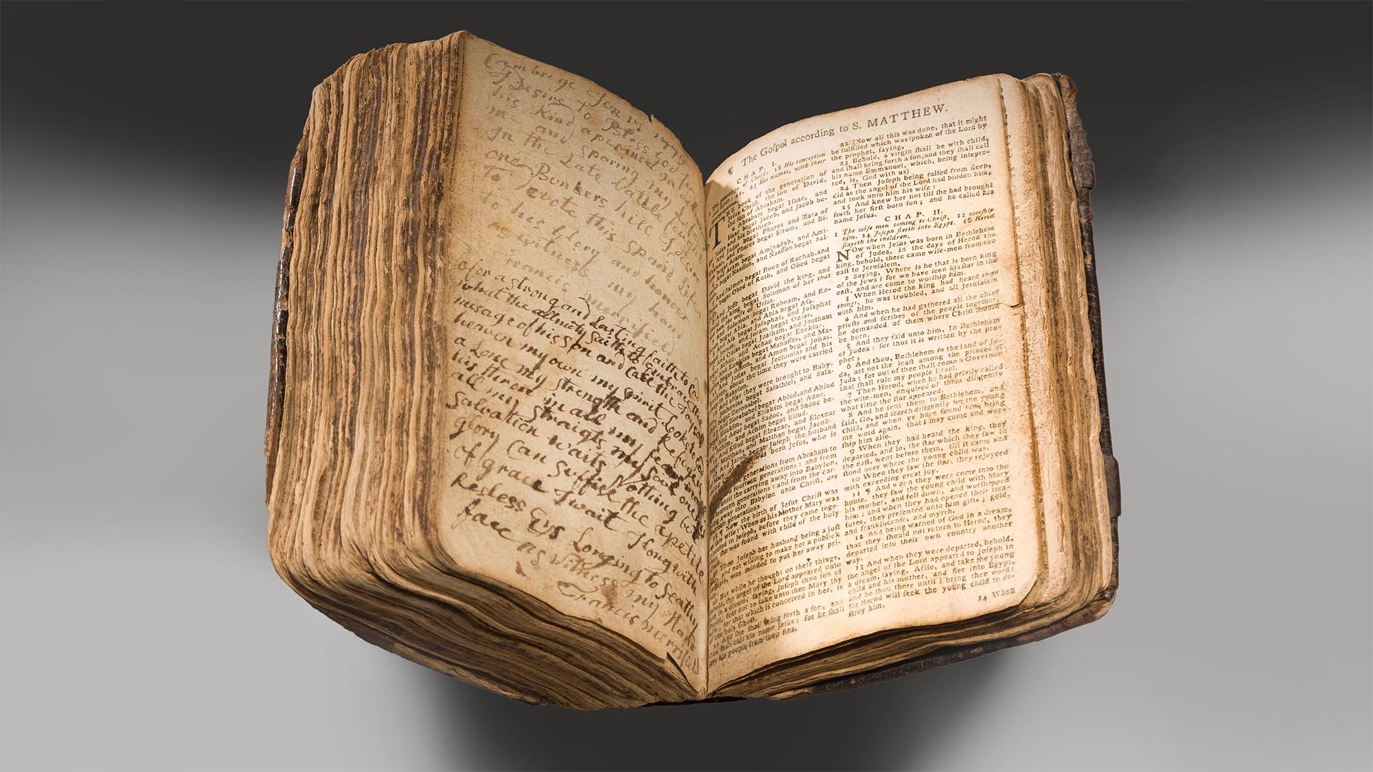 This image shows the Bunker Hill Bible. It is open to The Gospel according to Matthew. It is displayed against a white background.