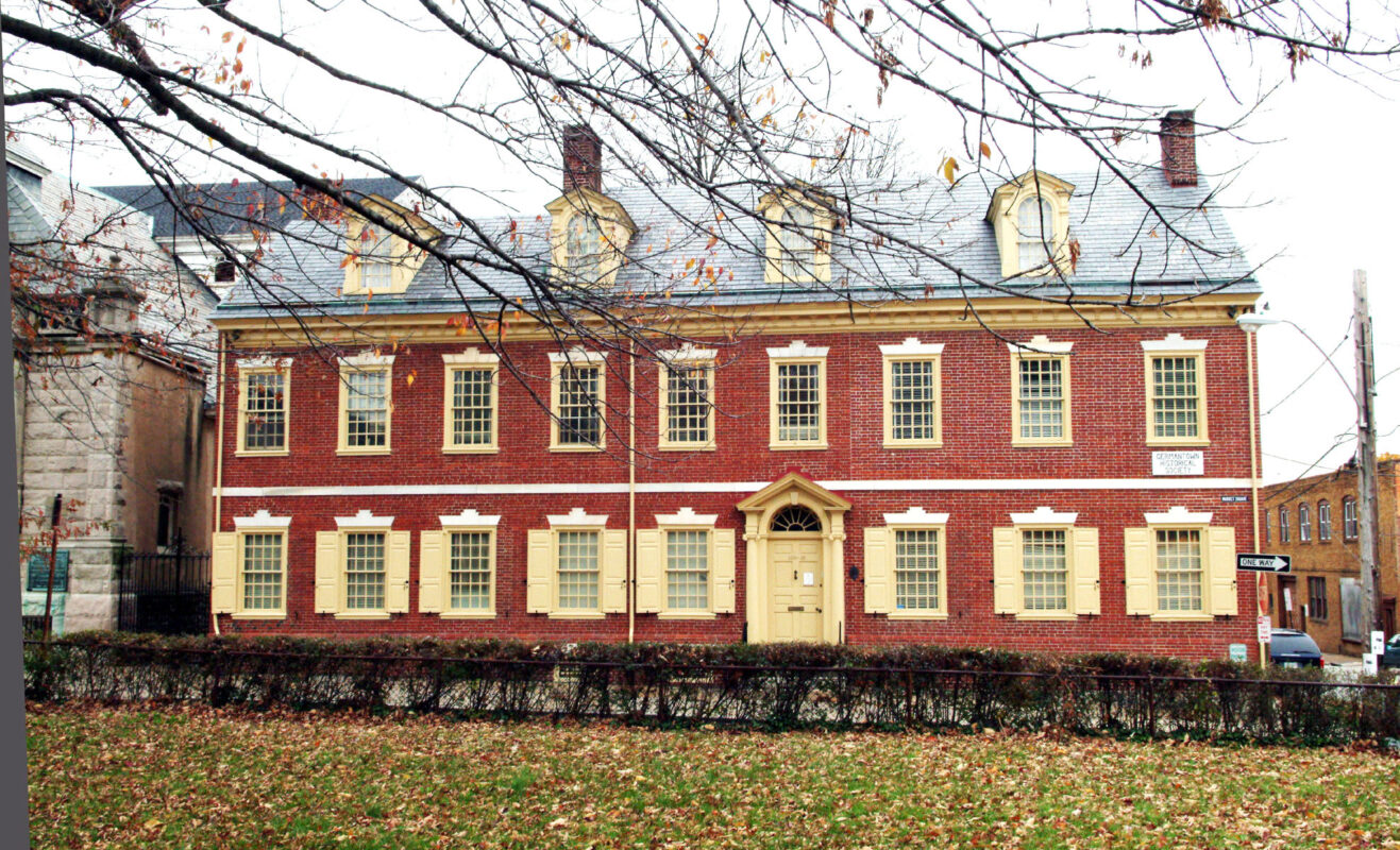 This image shows the red brick building with beige shutters for the Germantown Historical Society.