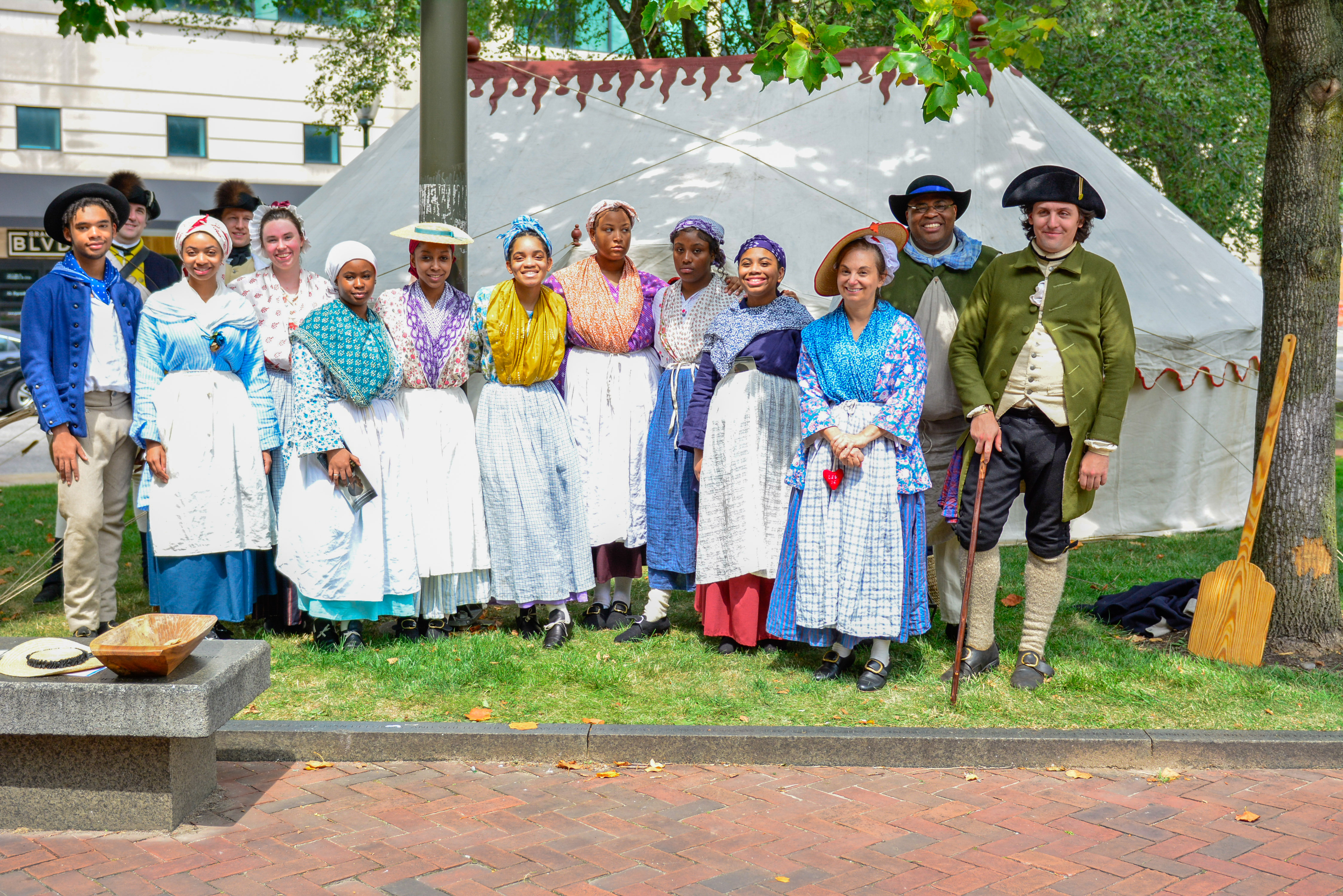 The 2023 Living History Youth Summer Institute students and additional costumed living history interpreters pose for a group photo in front of the Museum's replica of George Washington's tent.