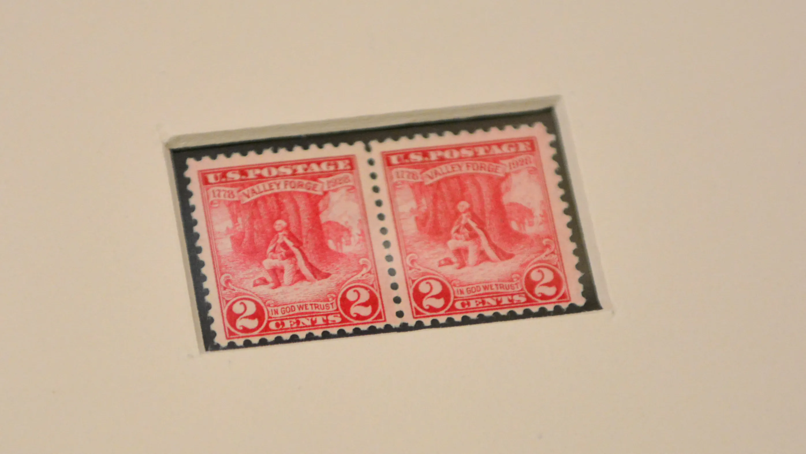 A pair of two-cent stamps featuring an image of Washington's prayer at Valley Forge.