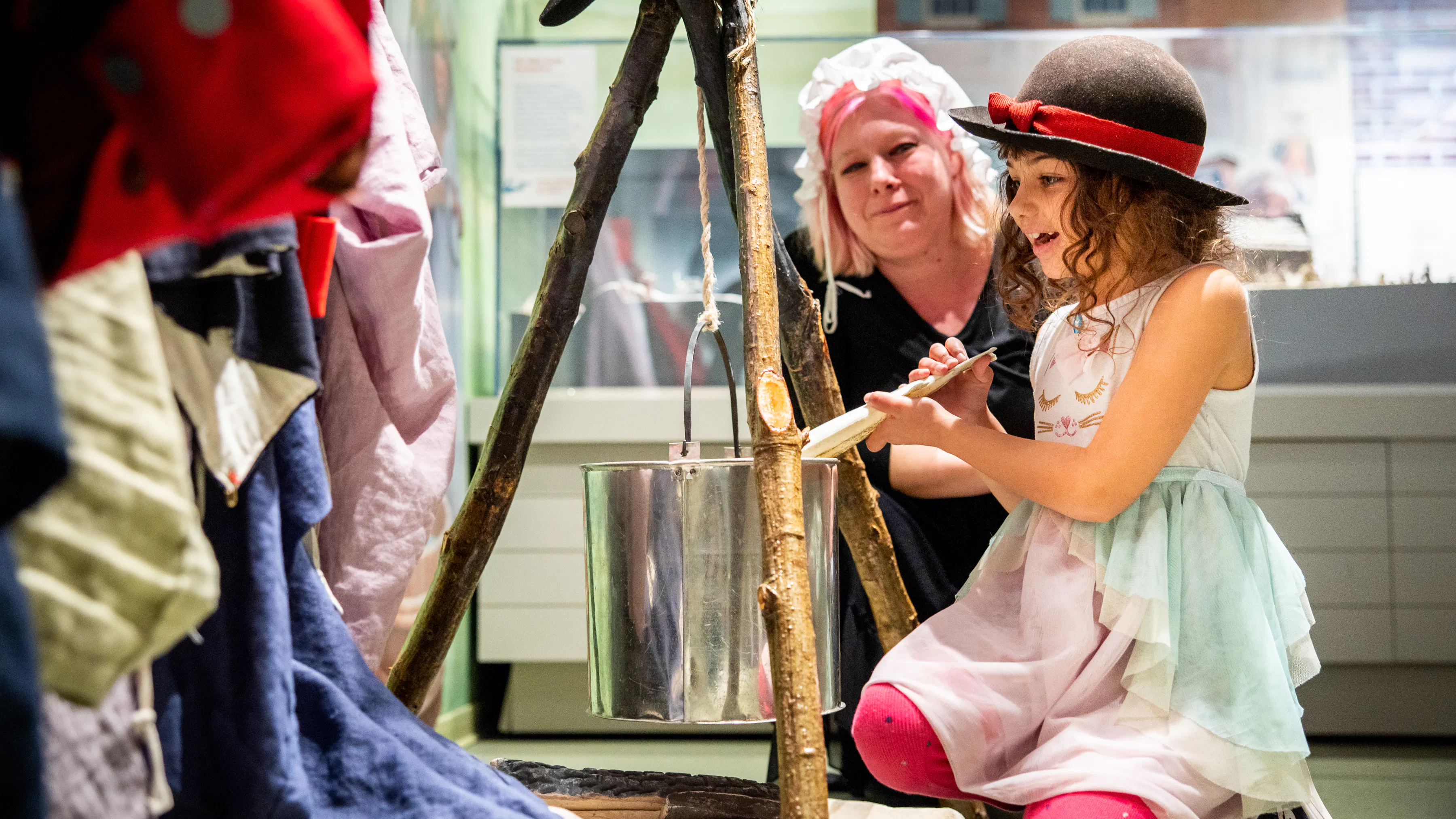 A mother and daughter interact at a replica encampment in the Museum's Revolution Place family discovery center.