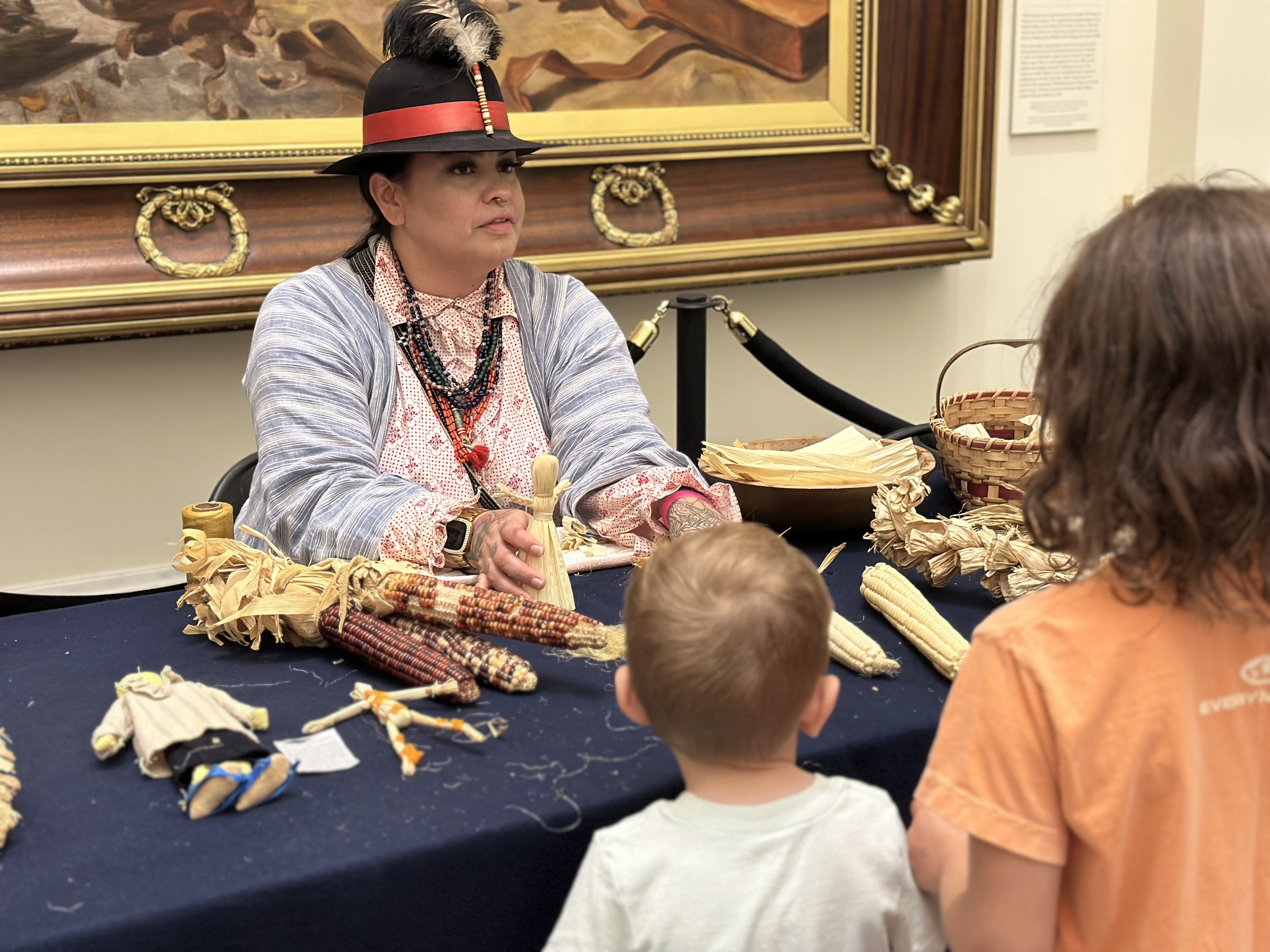 Kehala Smith of the Tuscarora Nation shows young guests traditional cornhusk dolls.