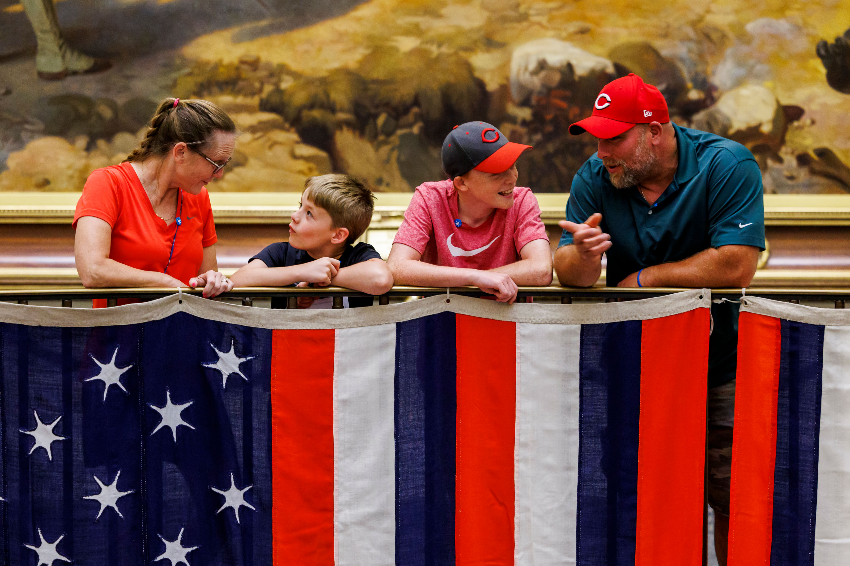 True Colours Flags with family of four looking over railing.