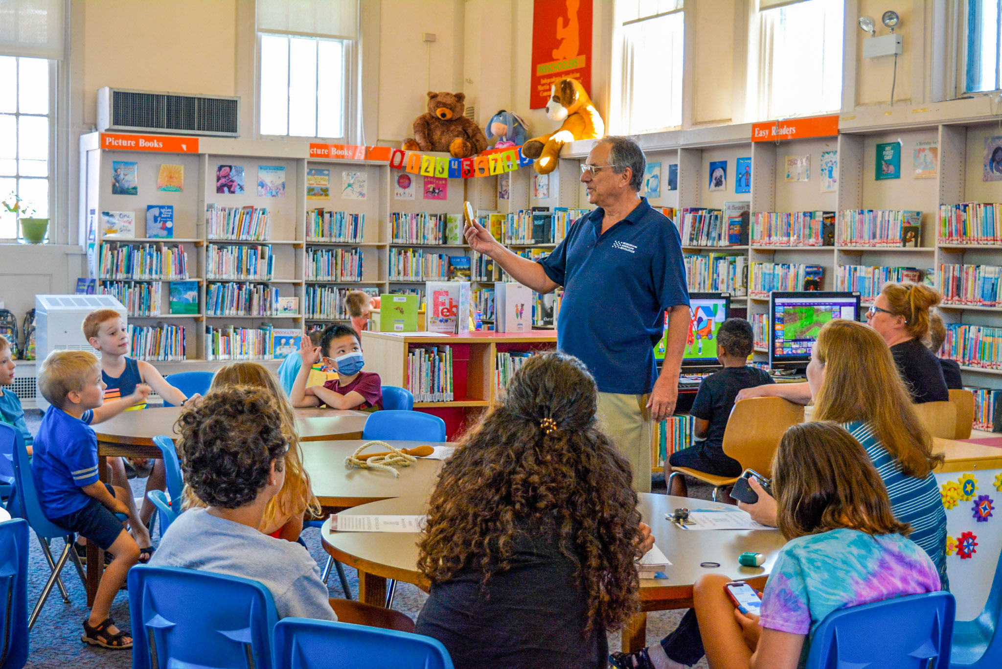 A Museum educator interacting with children at a Revolution At The Library event at the Free Library of Philadelphia Richmond Branch