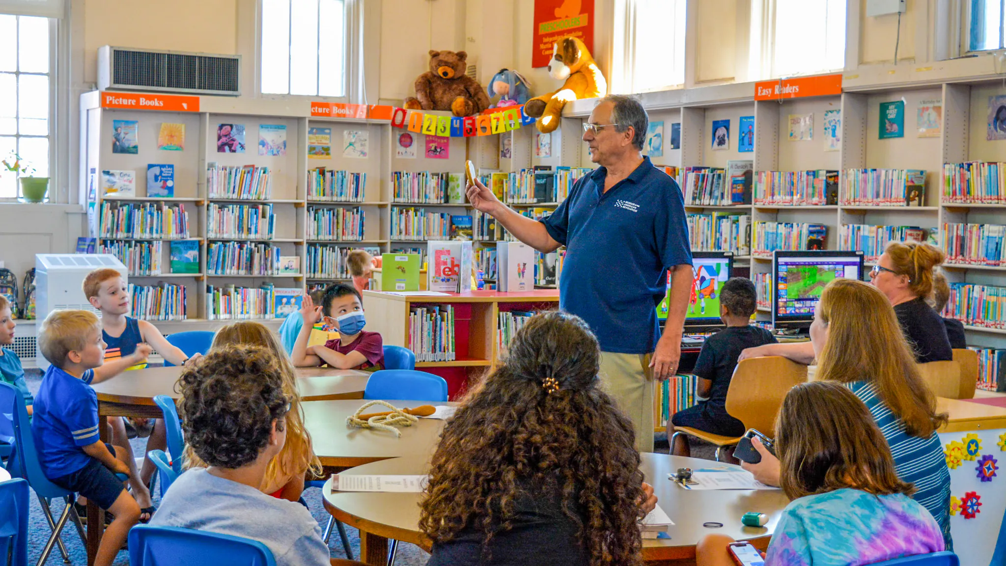 A Museum educator interacting with children at a Revolution At The Library event at the Free Library of Philadelphia Richmond Branch