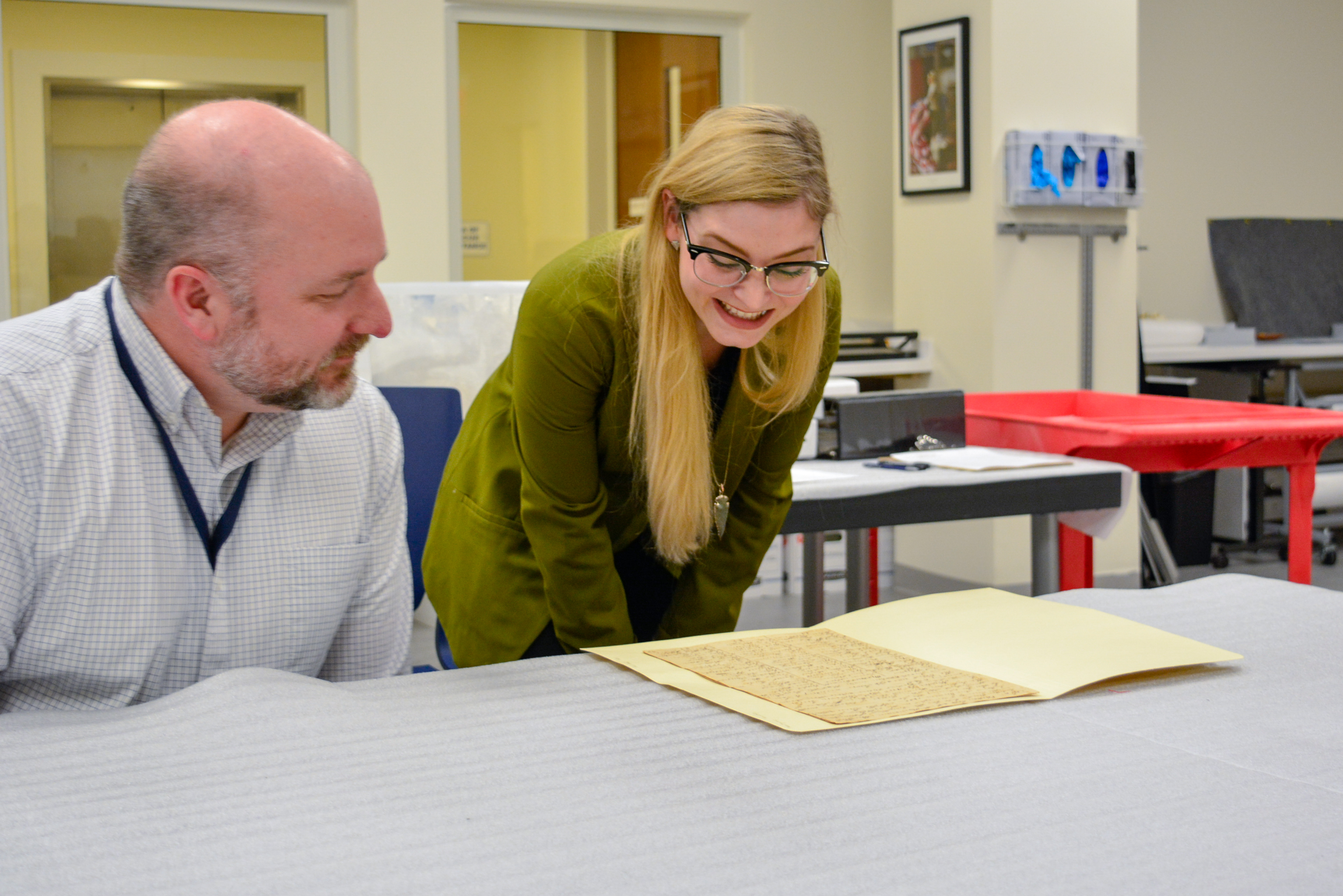Two professionals examining a Museum document