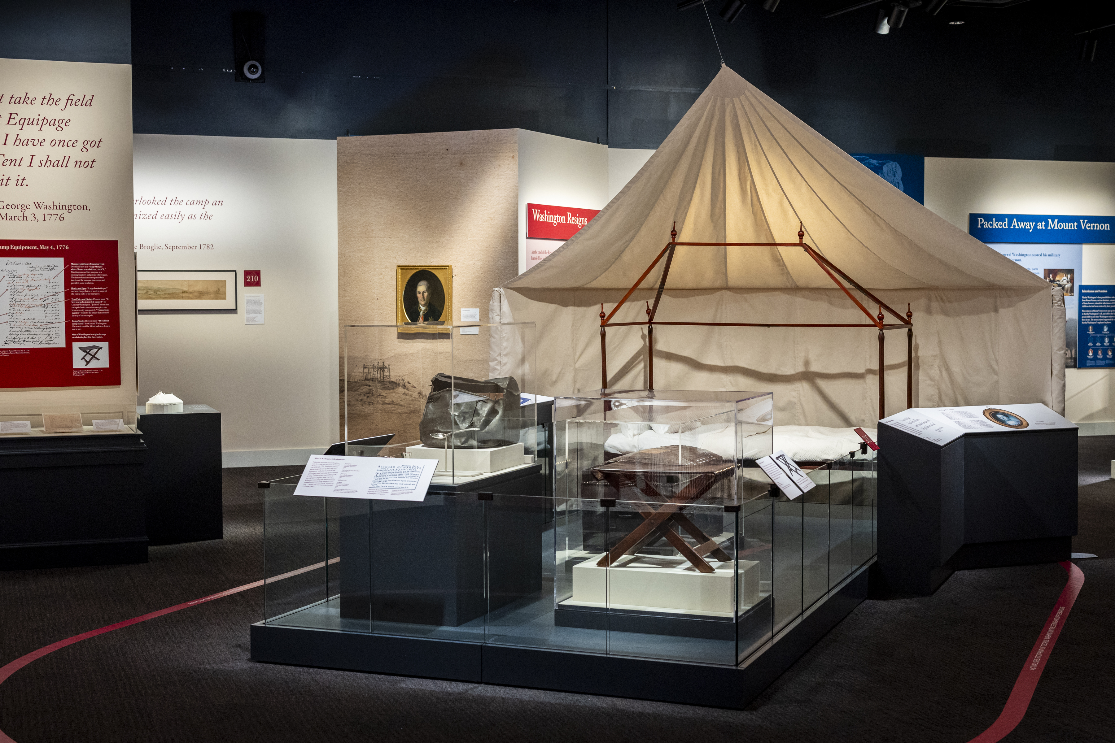 A recreated of an end of Washington's tent displayed with his camp bed and additional camp items.