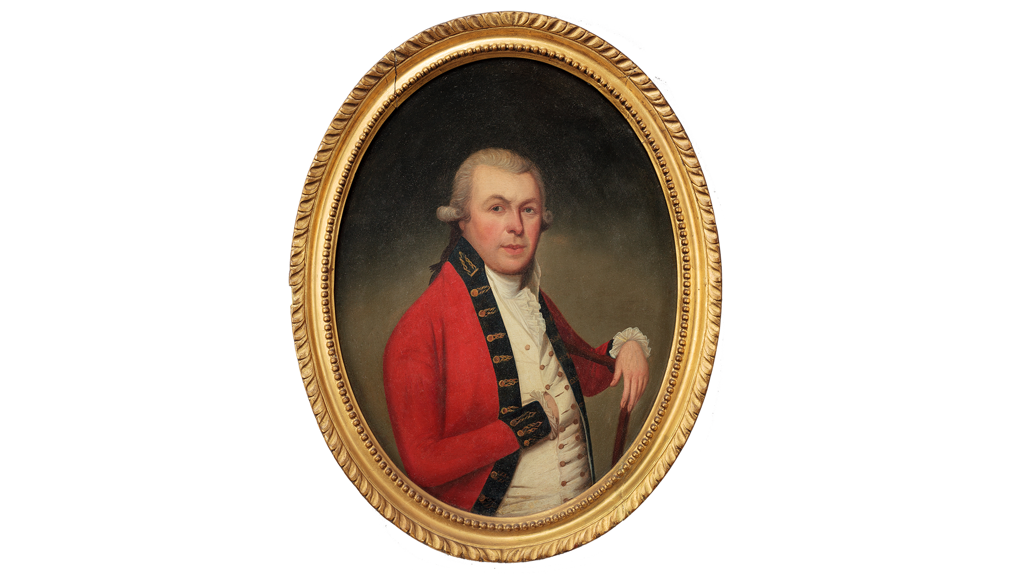 This image shows a gold framed portrait of Thomas McDonogh. The portrait is against a white background. Thomas is wearing a red jacket with a blue shirt. His right hand is resting inside a buttonhole of the shirt, so you cannot see his hand. His left wrist is placed on the wooden chair he is sitting on, with his hand dangling over. His eyebrows are raised as he stares at the viewer.