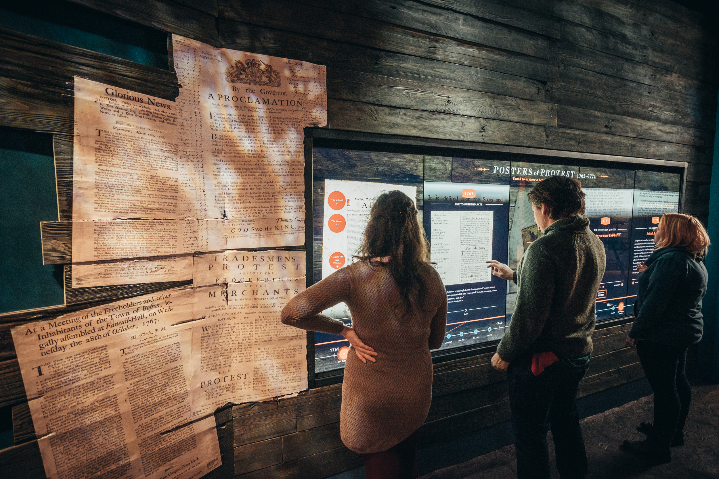 Museum guests enjoying the opening of a new exhibit, Posters of Protest.