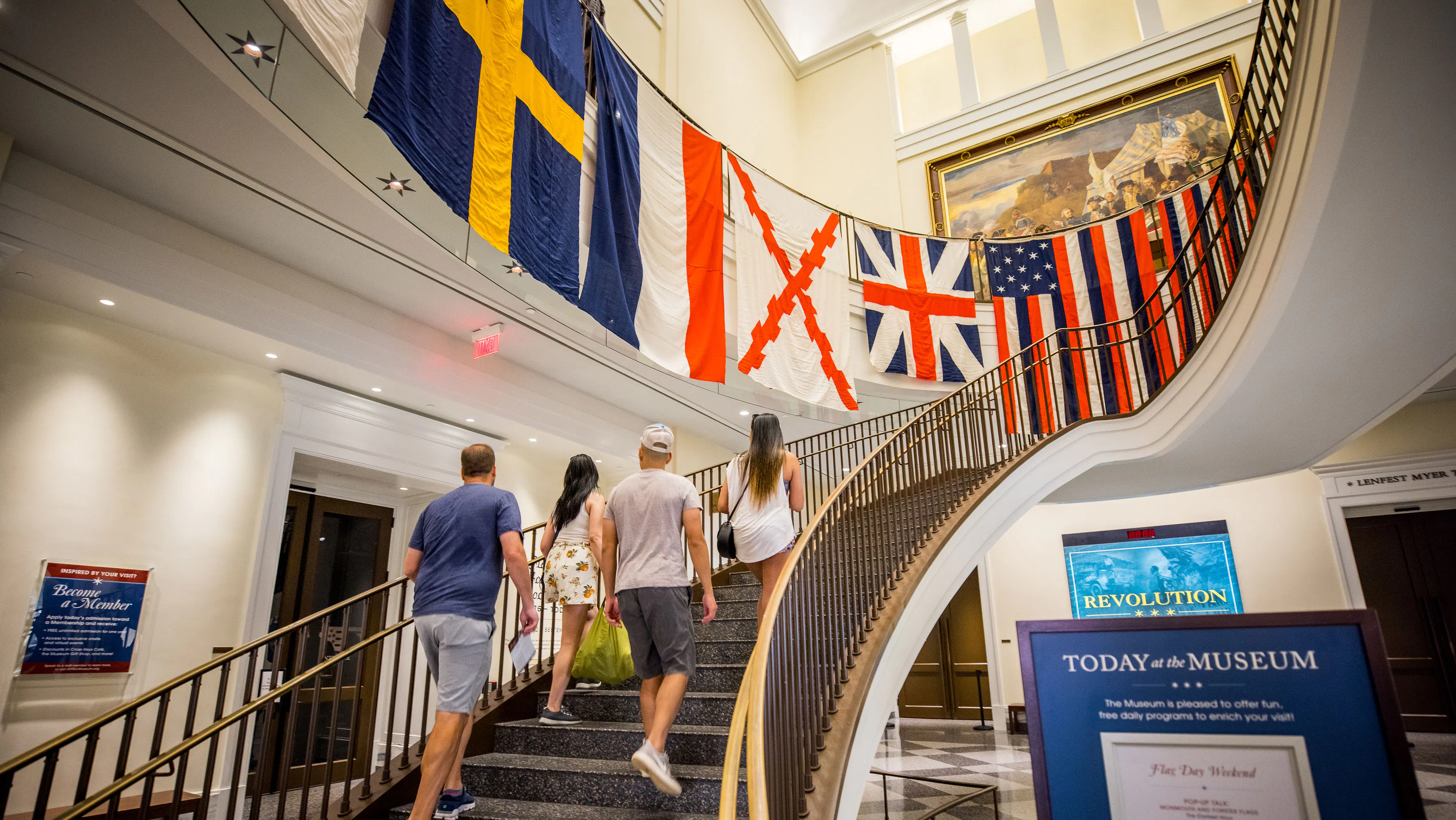A collection of different flags hanging in the Museum rotunda, from the Flags and Founding Documents exhibit